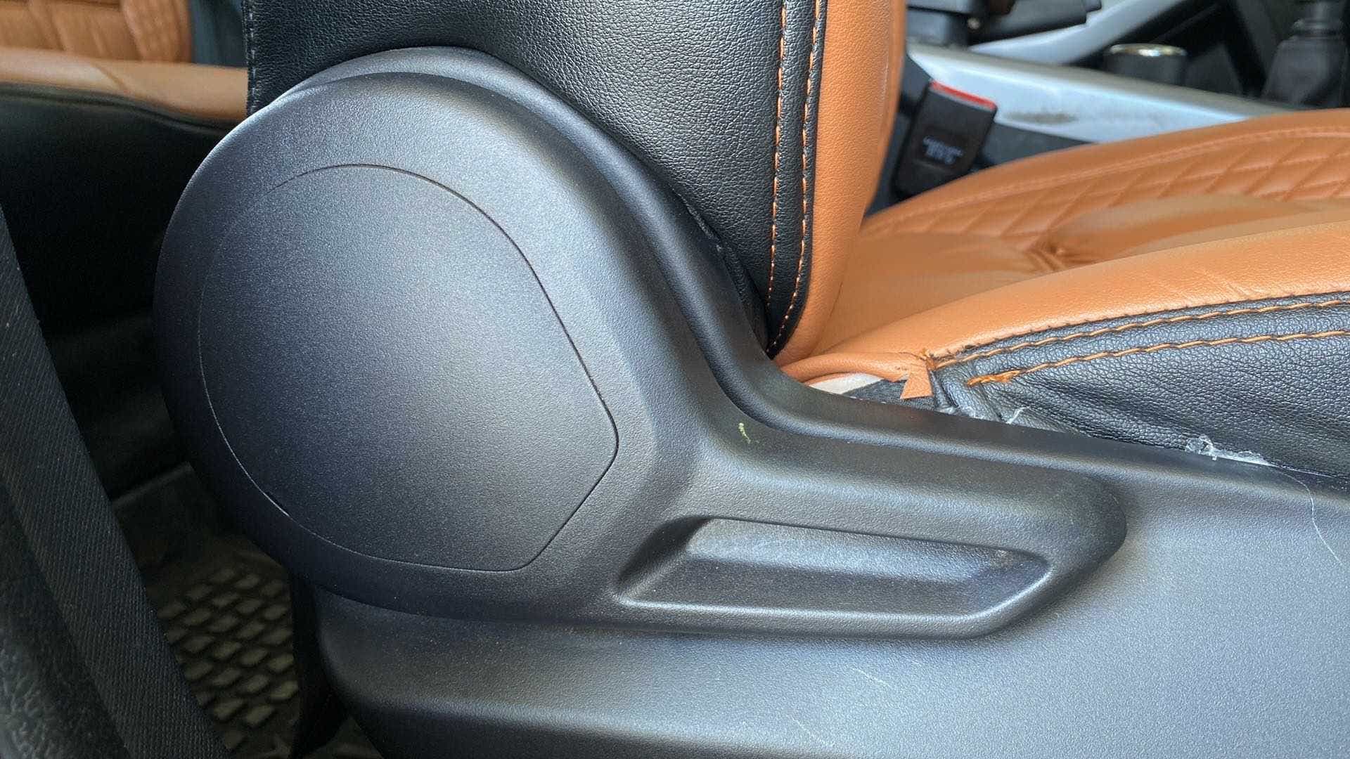 Seat adjustment lever and stitching detail of a Tata Nexon 2017-2023
