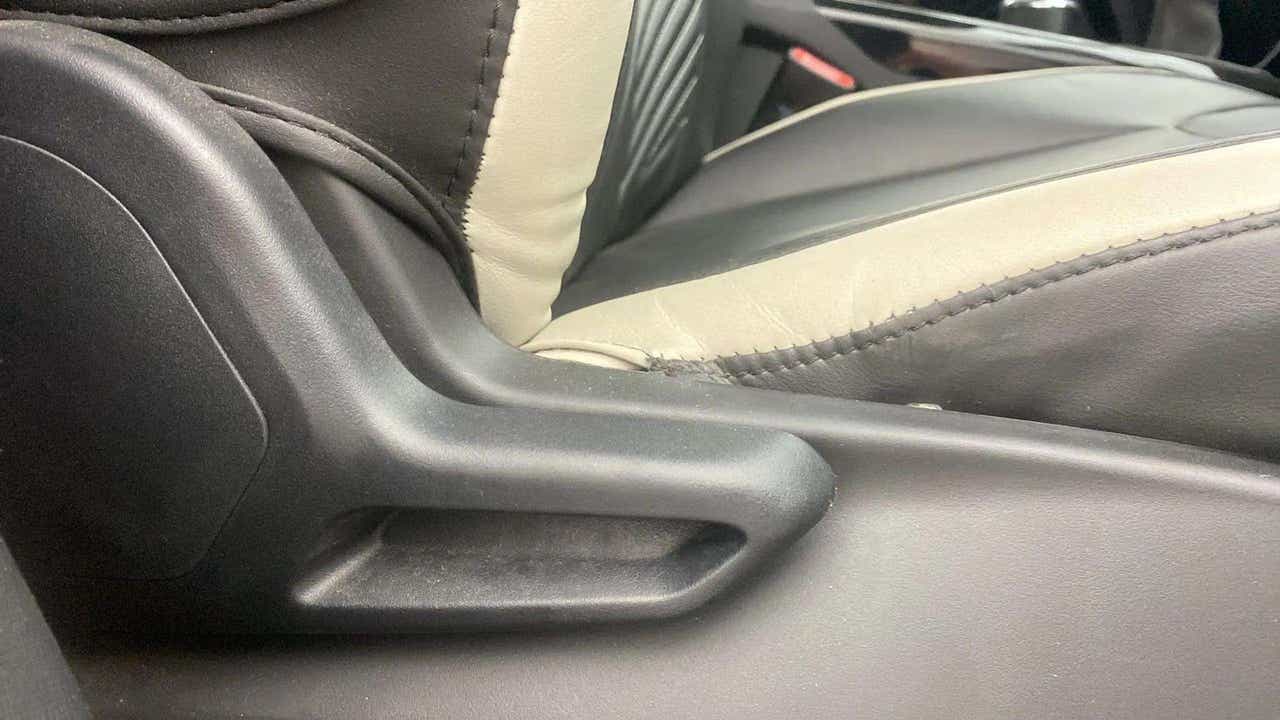 Close-up of seat adjustment lever and upholstery of a Tata Nexon