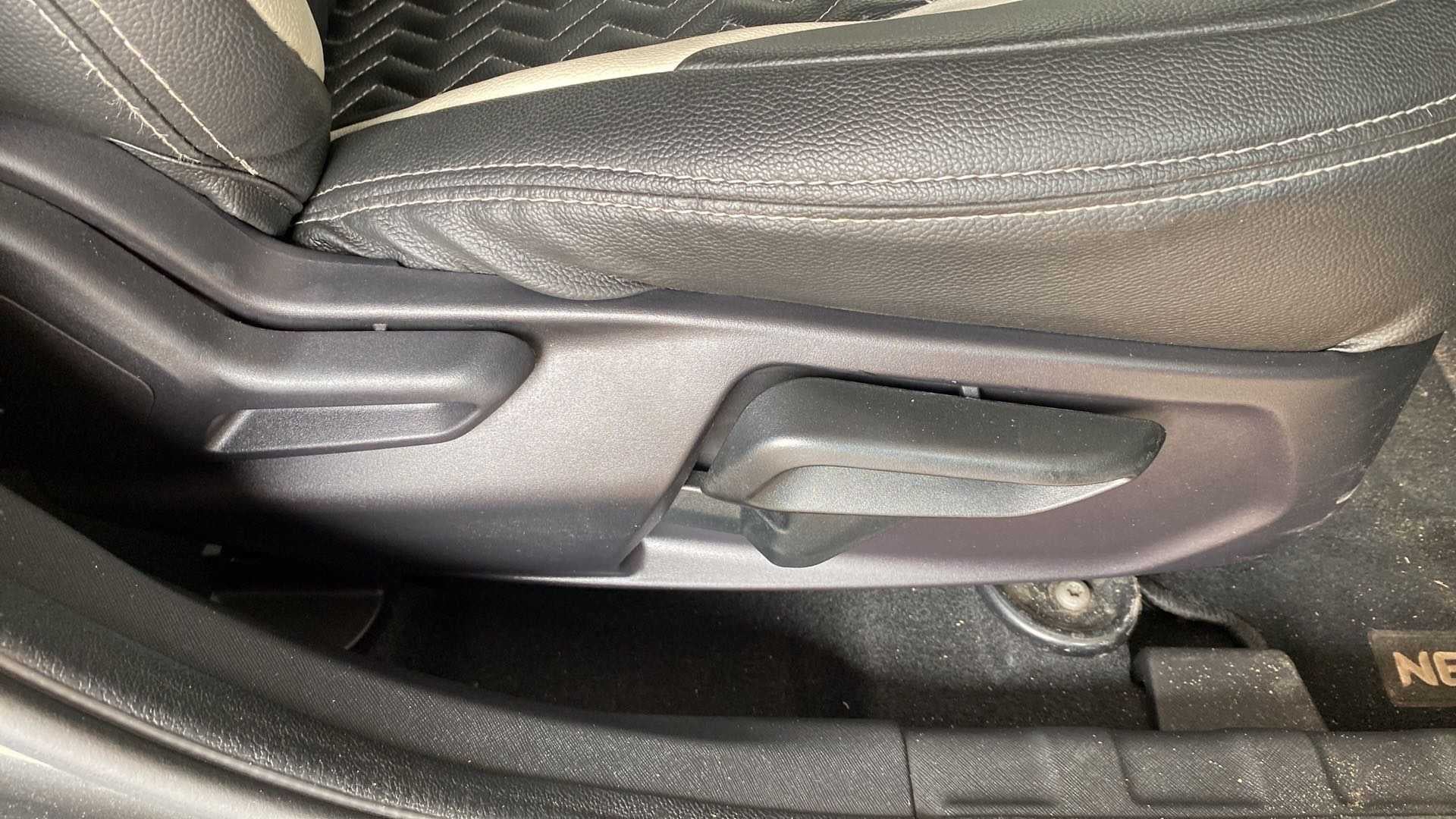 Close-up of the seat adjustment lever of a Tata Nexon 2017-2023