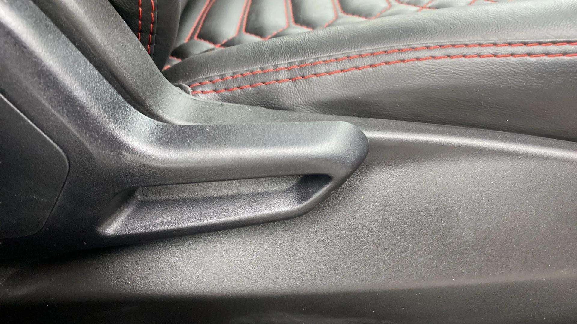 Close-up of a seat adjuster and leather stitching on a Tata Nexon