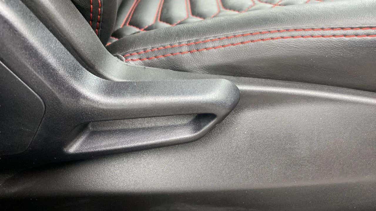 Close-up of a seat adjuster and leather stitching on a Tata Nexon
