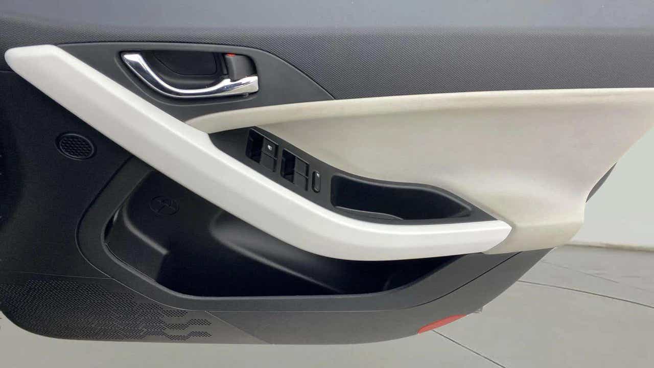 Close-up of front door panel and controls of a Tata Nexon