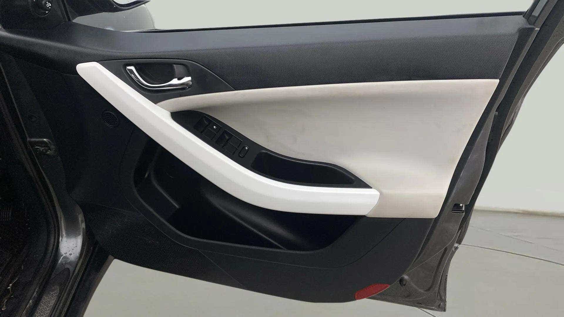 Interior driver side door panel of a Tata Nexon