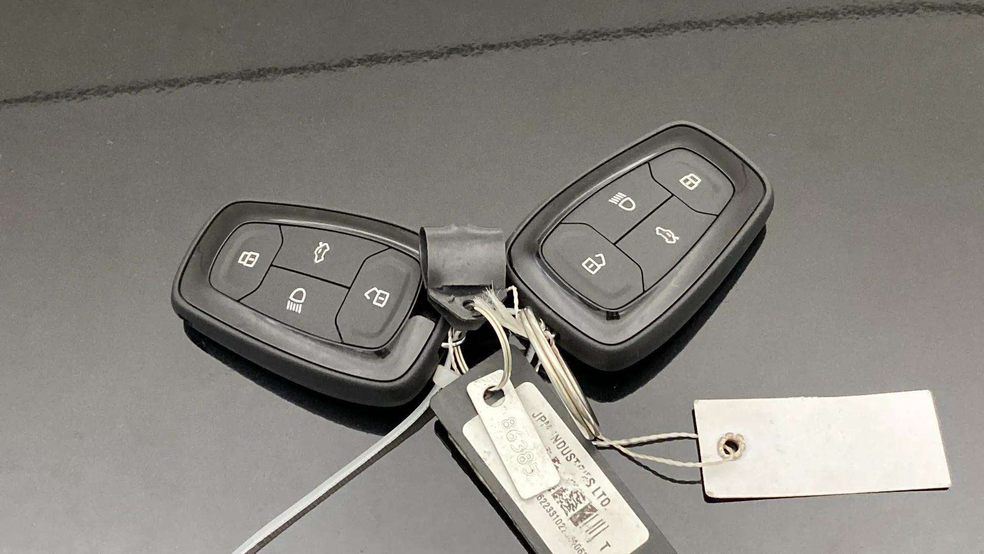 Car keys on the bonnet of a Tata Nexon 2017-2023