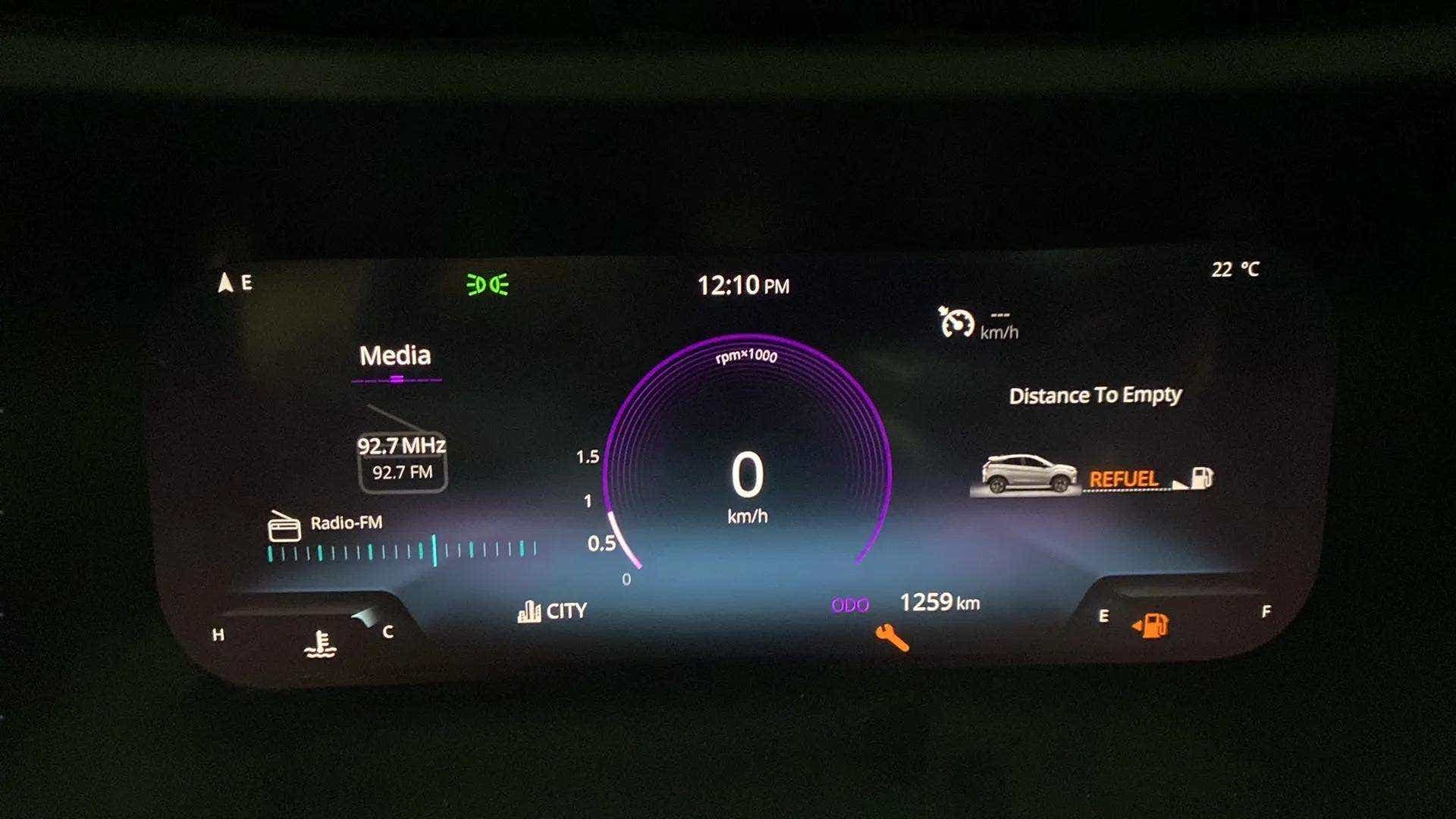 Instrument cluster display of a Tata Nexon 2017-2023 showing speedometer and media info