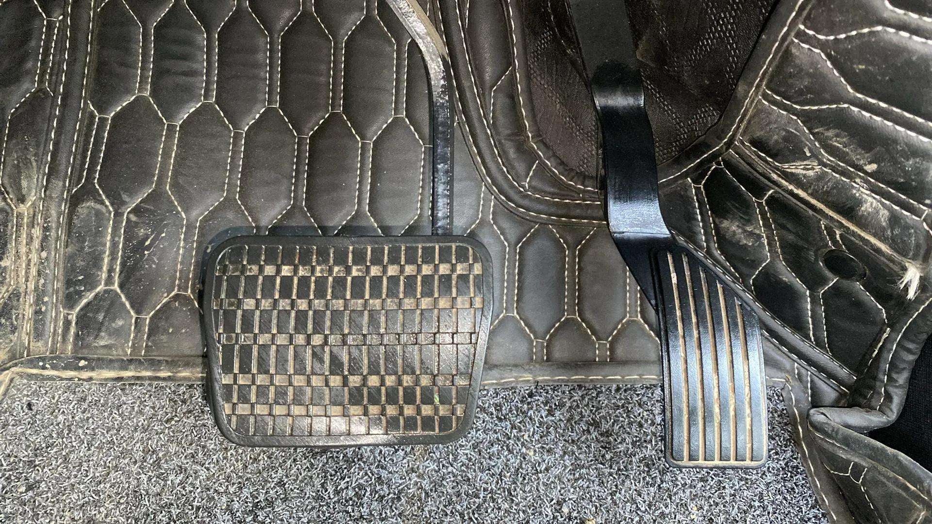 Close-up view of the foot pedals of a Tata Nexon.