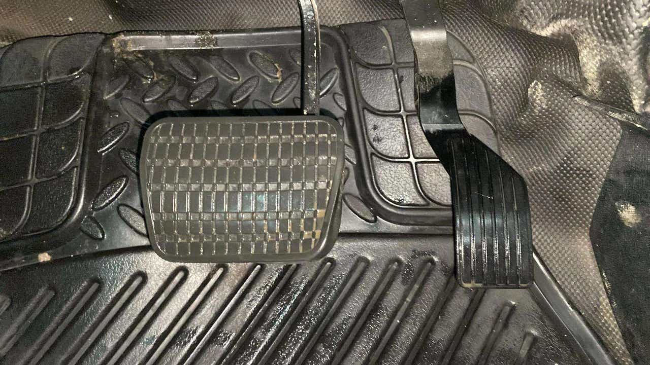Footwell view showing brake and accelerator pedals of a Tata Nexon