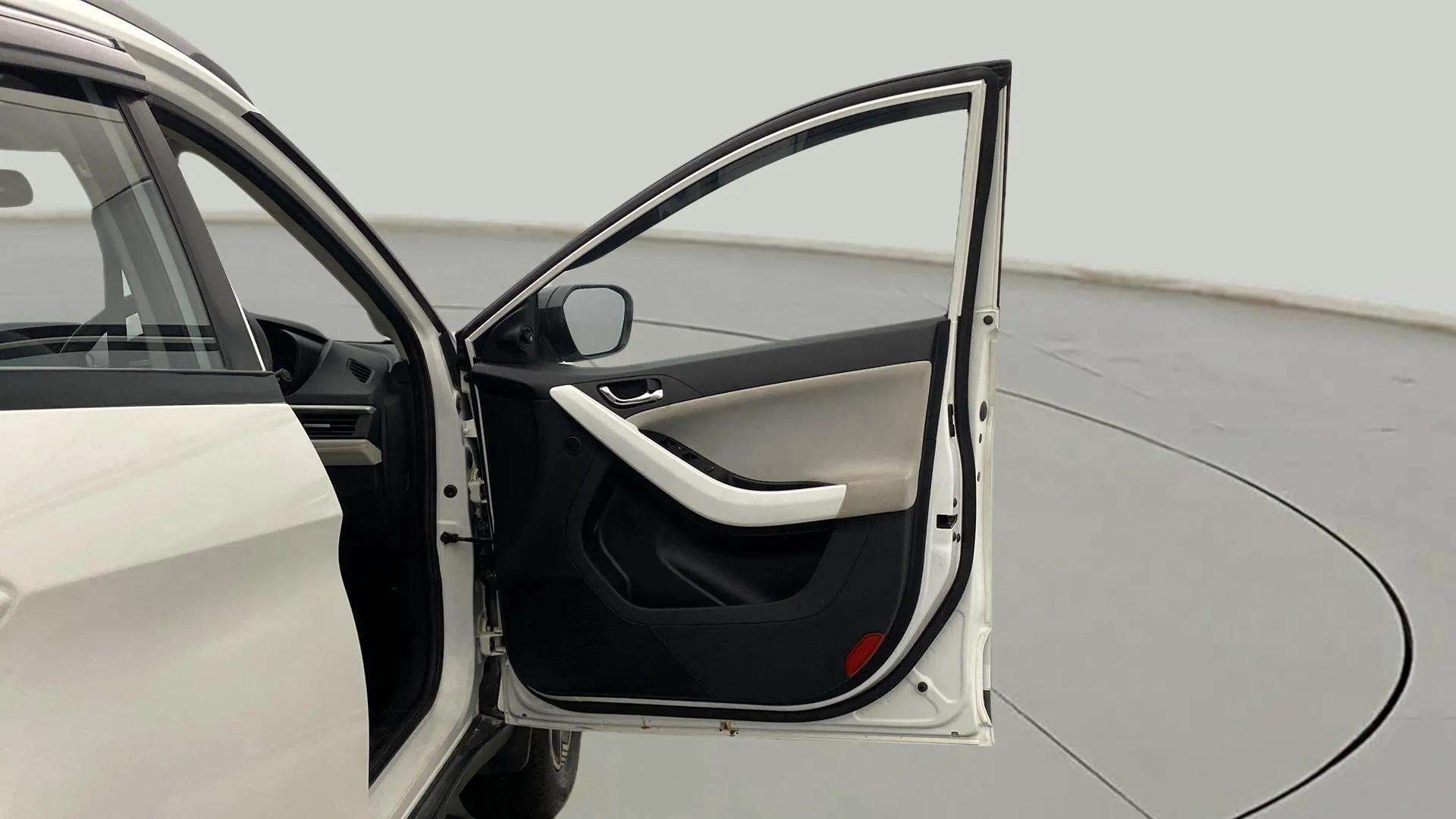 Front driver-side door and interior panel of a Tata Nexon