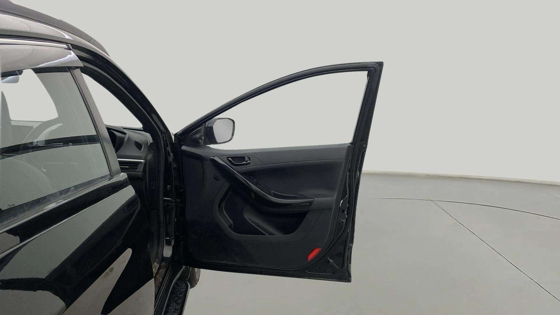 Driver door open view of a Tata Nexon