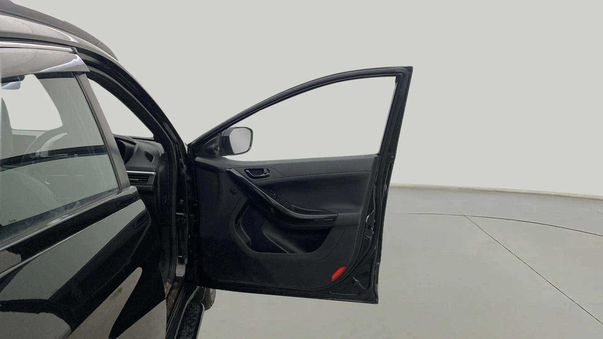 Driver door open view of a Tata Nexon