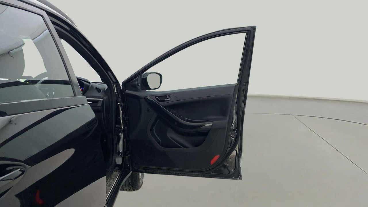Open driver side door view of a Tata Nexon