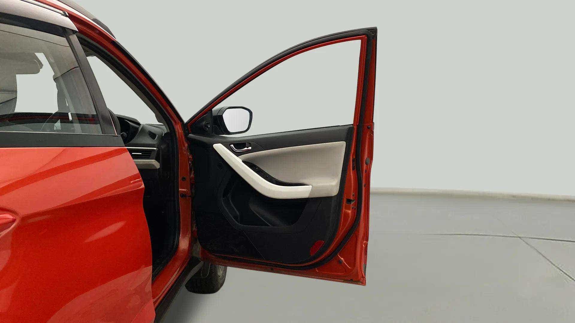 Driver side door open view of a Tata Nexon