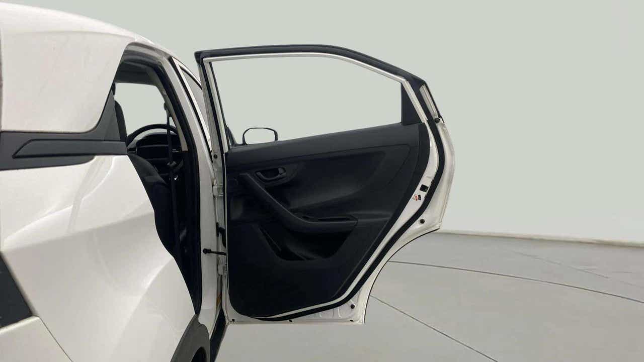Rear left open door view of a Tata Nexon