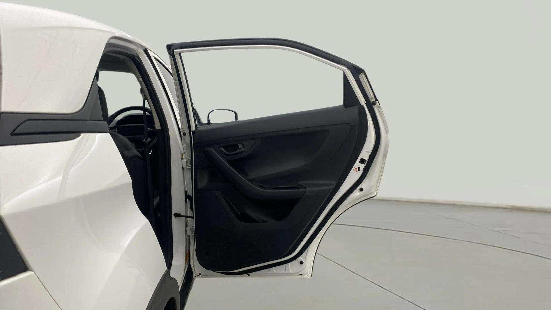 Rear left open door view of a Tata Nexon