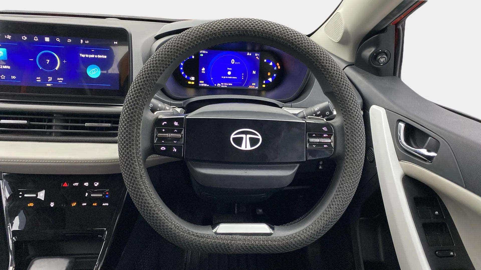 Interior dashboard and steering wheel of a Tata Nexon
