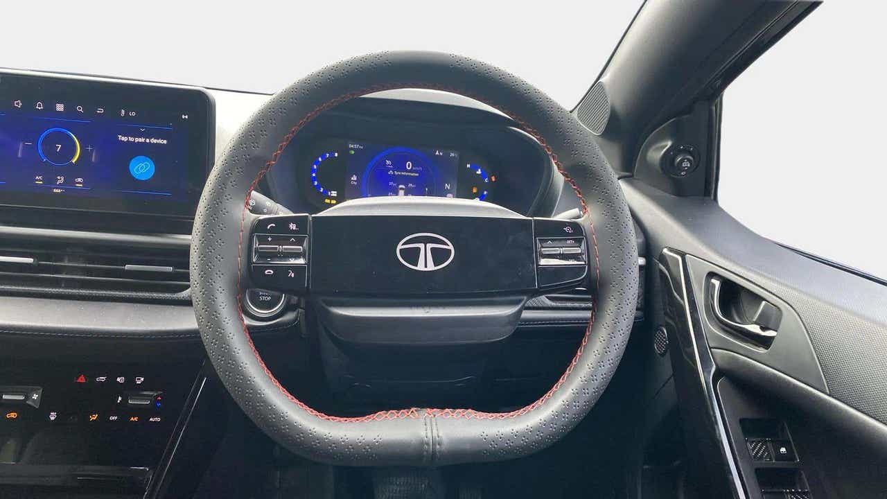 Steering wheel and dashboard view of a Tata Nexon
