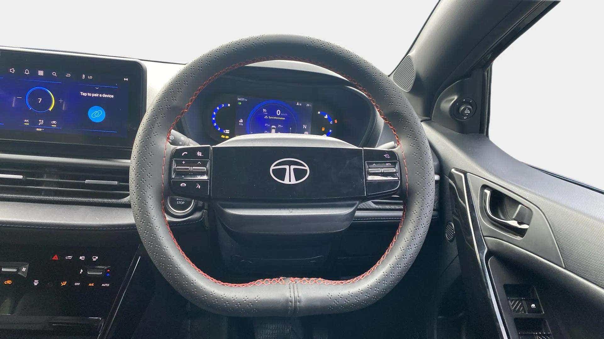 Steering wheel and dashboard view of a Tata Nexon