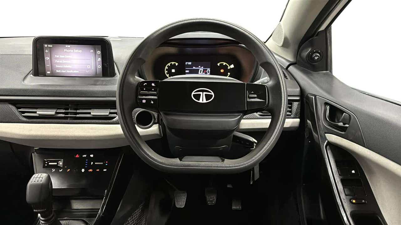 Interior dashboard and steering wheel of a Tata Nexon