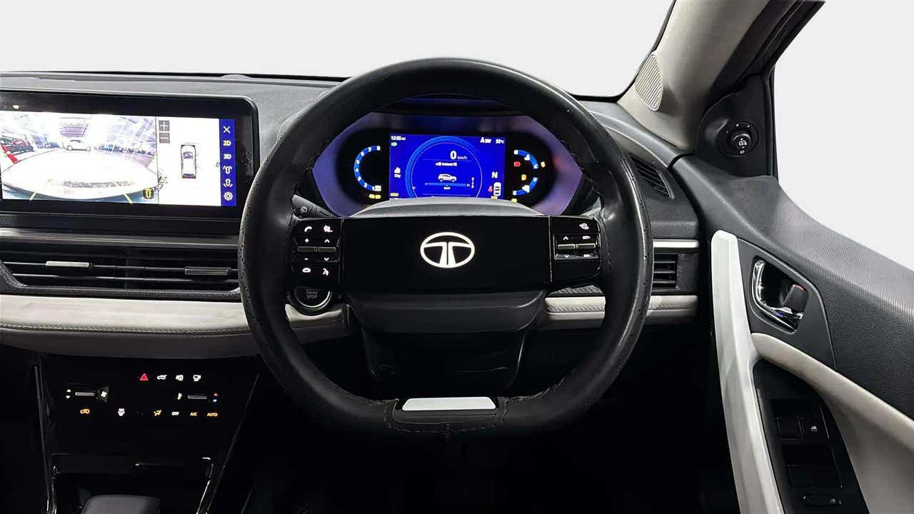 Interior dashboard and steering wheel of a Tata Nexon