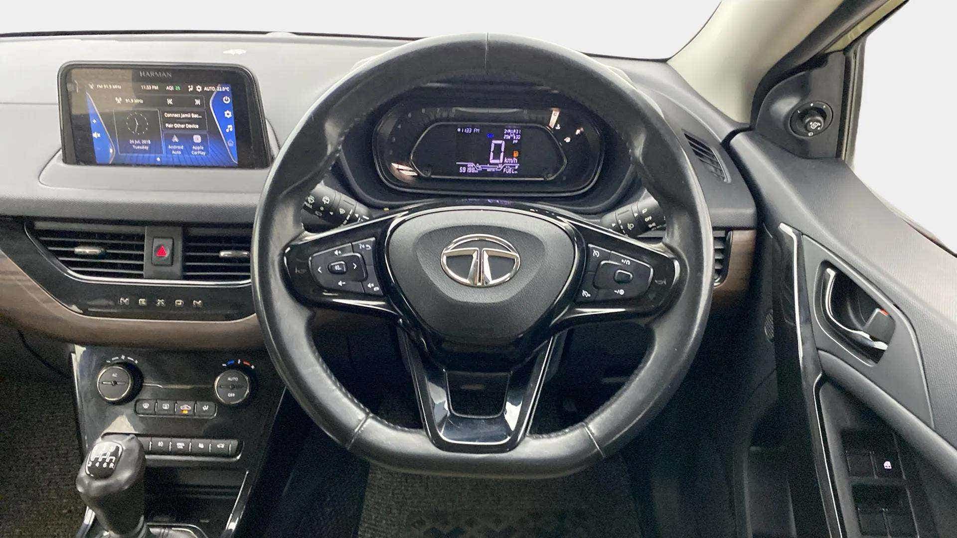 Dashboard and steering wheel view of a Tata Nexon 2017-2023