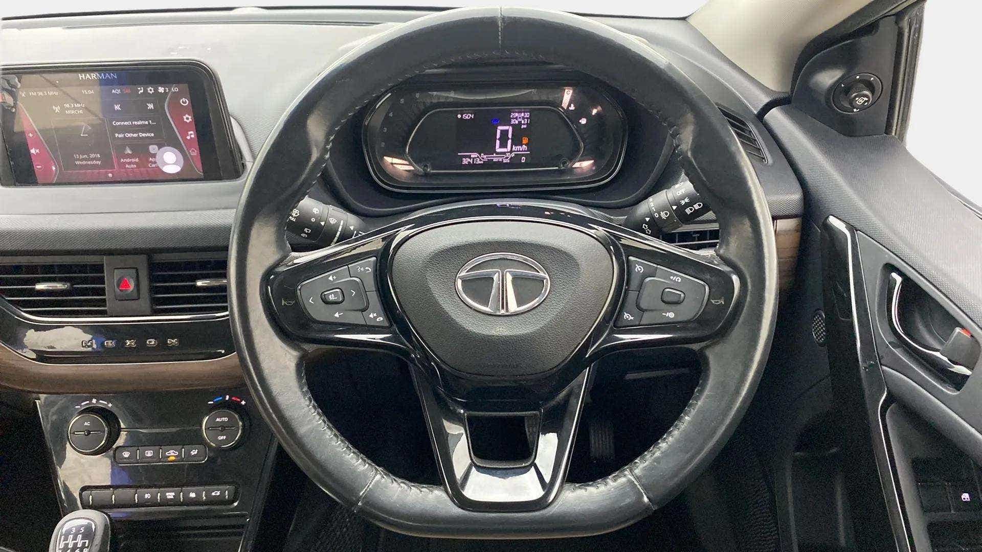 Interior dashboard and steering wheel of a Tata Nexon 2017-2023