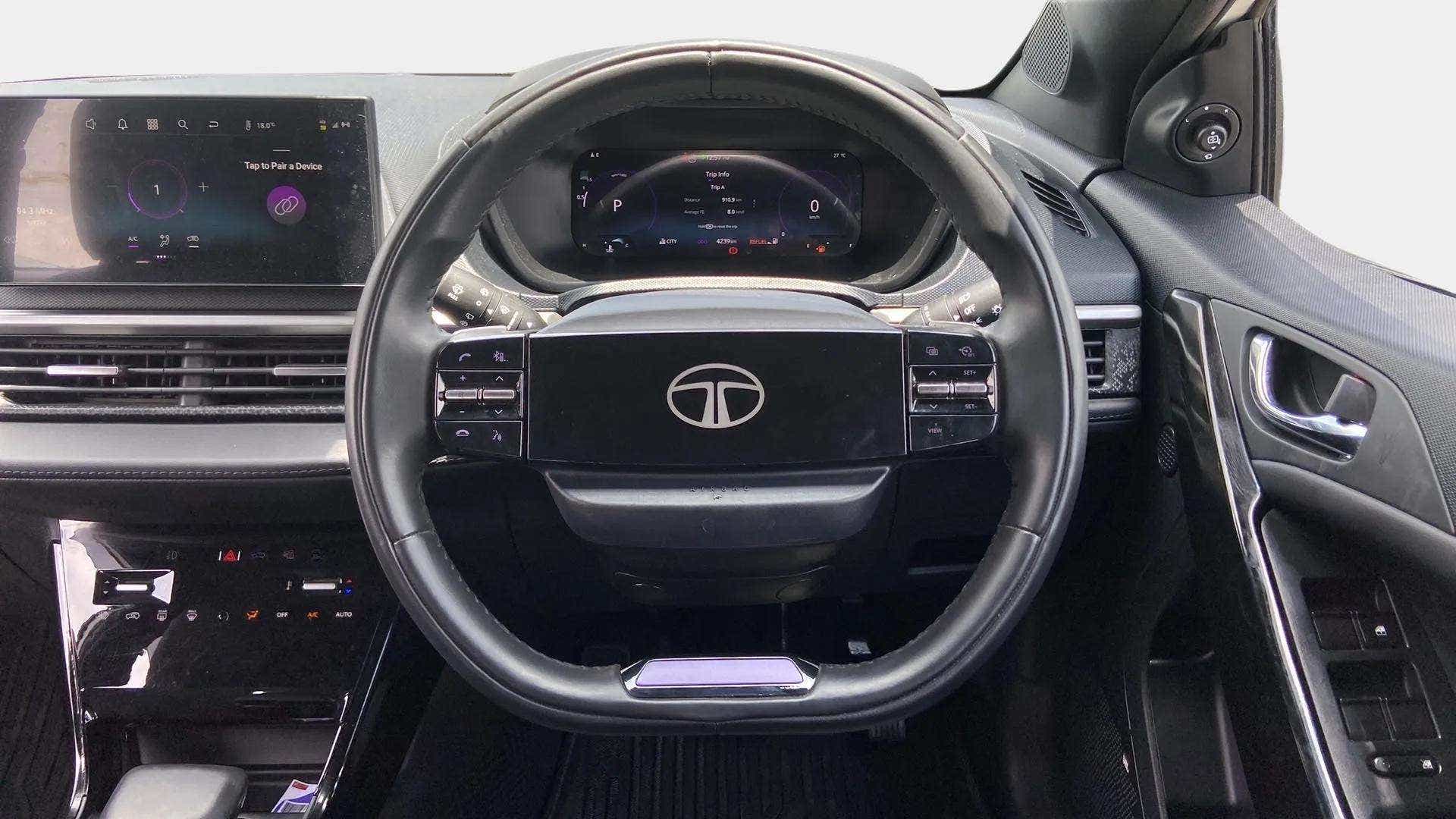 Interior dashboard and steering wheel of a Tata Nexon