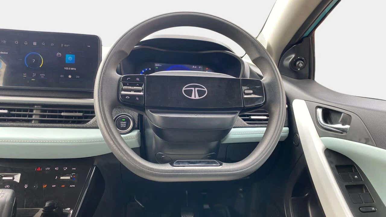 Dashboard and steering wheel interior view of a Tata Nexon