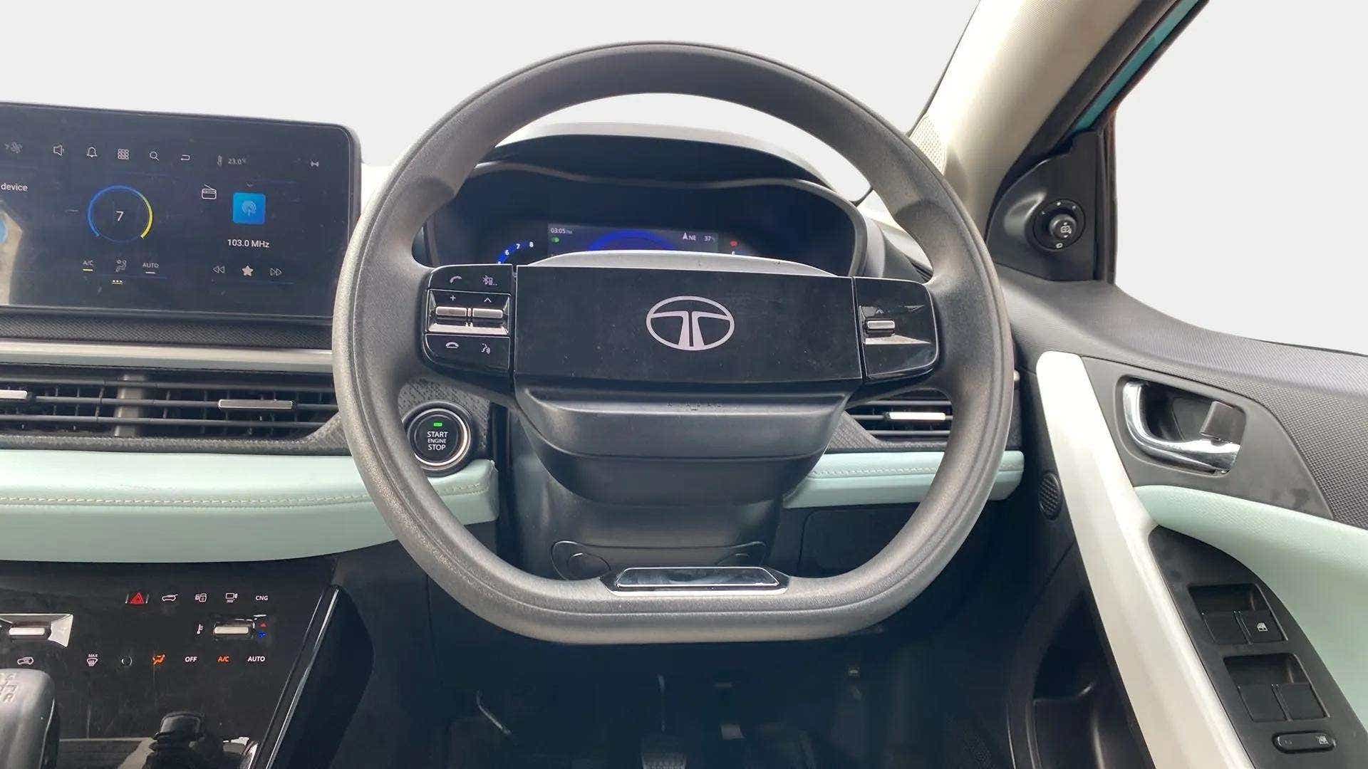 Dashboard and steering wheel interior view of a Tata Nexon