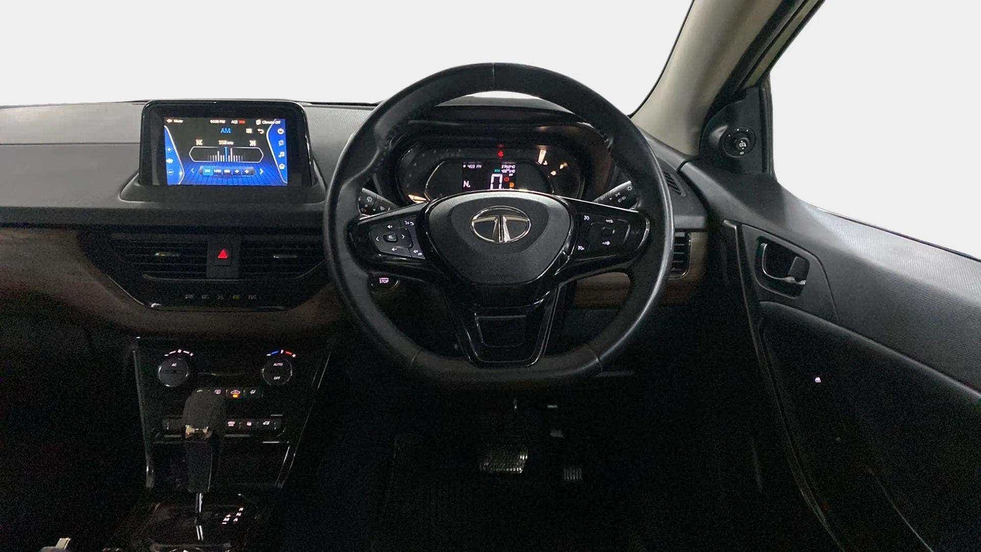 Dashboard and steering wheel view of a Tata Nexon 2017-2023