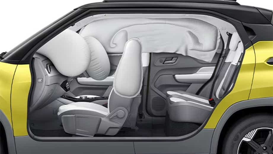 Side cutaway view of a fearless yellow with dt Tata Punch EV Facelift showing deployed airbags