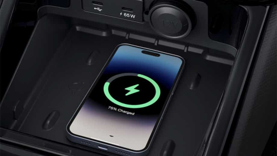 Wireless charging pad with phone in a black Tata Punch Facelift