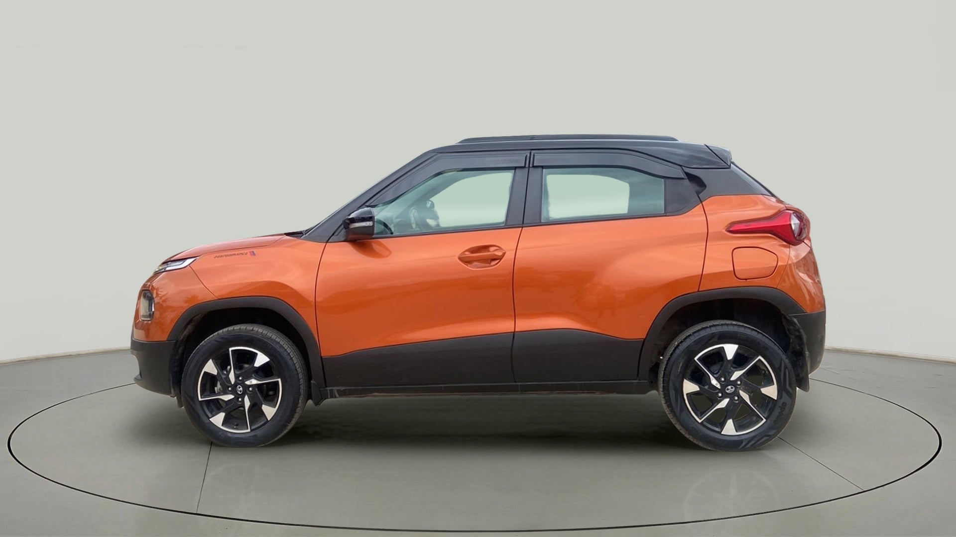 Side view of an Atomic Orange Tata Punch