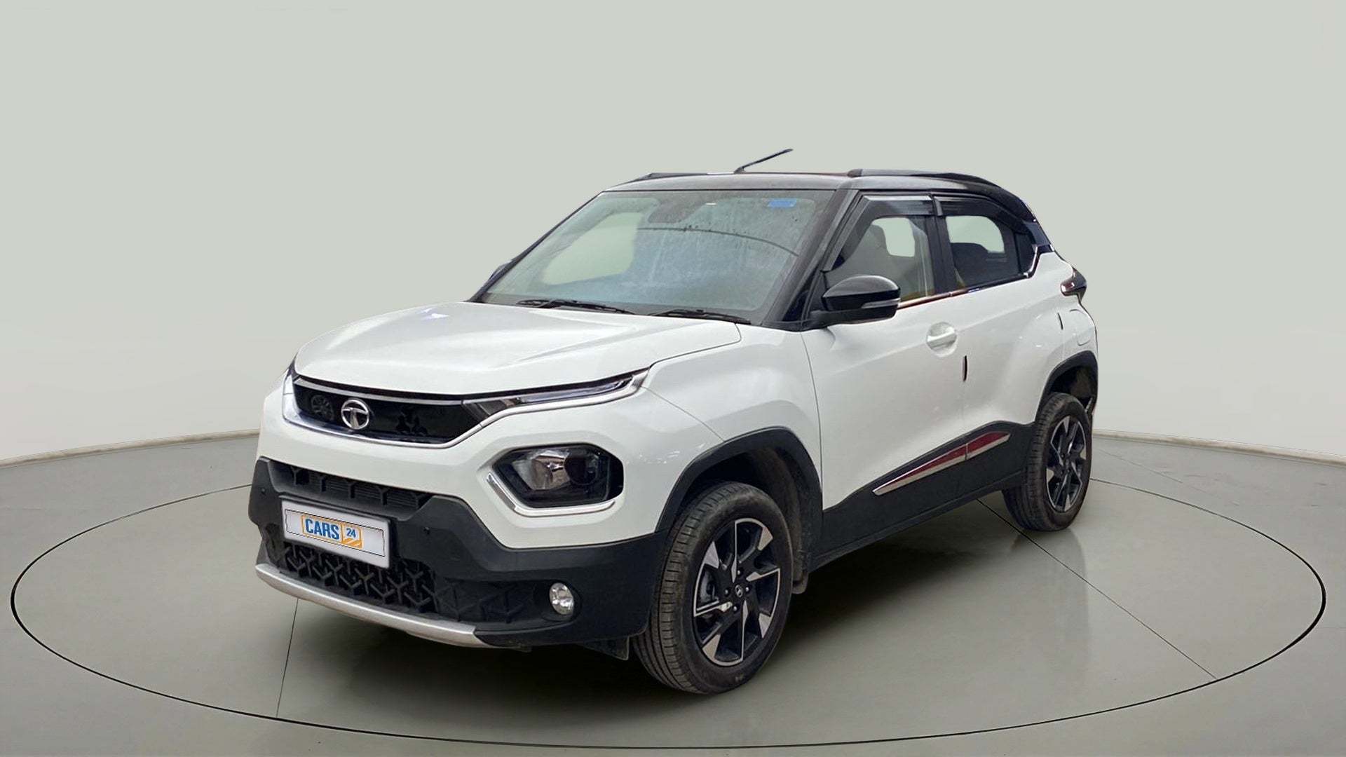 Front three-quarter view of a Calypso Red with White Roof Tata Punch