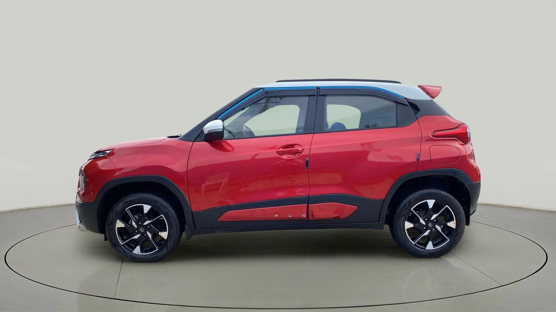 Side view of a Calypso Red with White Roof Tata Punch