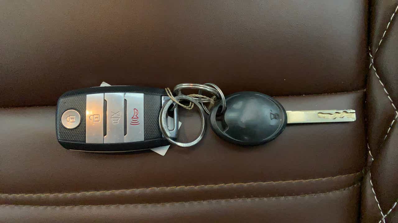 Car key fob and key on brown leather seat of a Tata Punch