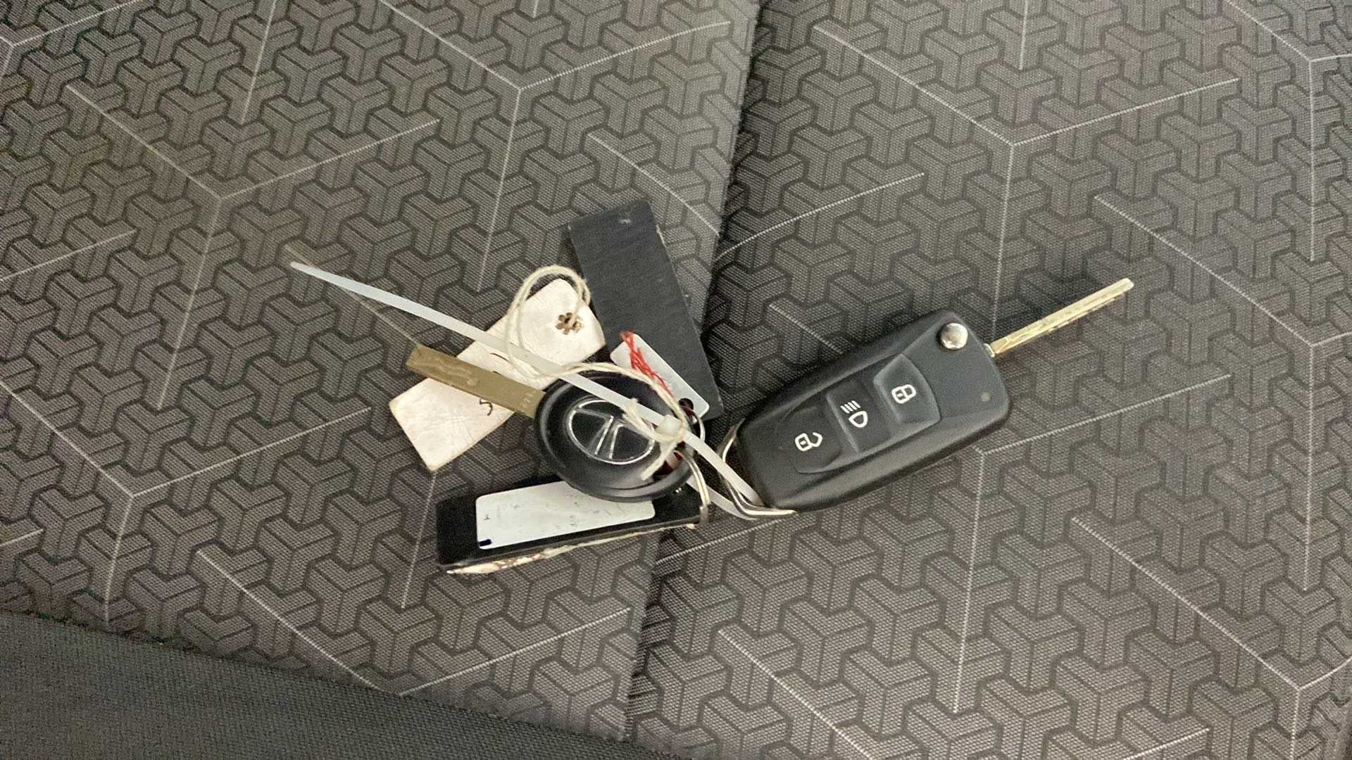 Car key fob and traditional key on seat of a Tata Punch