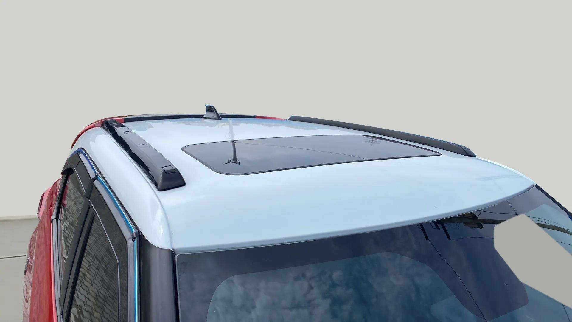 Sunroof and roof rails view of a Calypso Red with White Roof Tata Punch