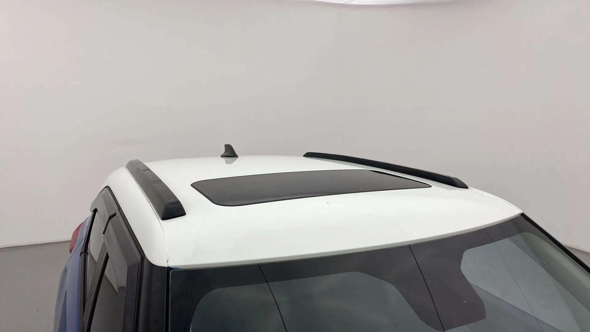 Sunroof and roof rails view of a calypso red with white roof Tata Punch