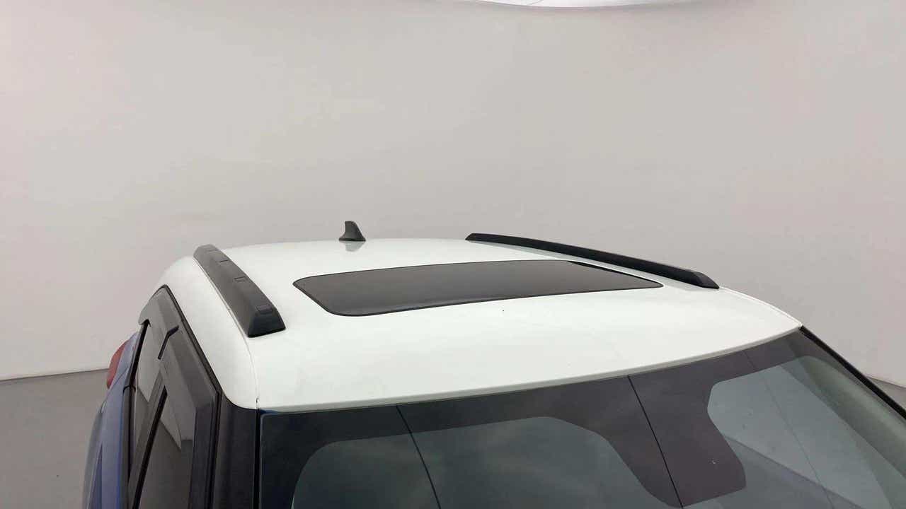 Sunroof and roof rails view of a calypso red with white roof Tata Punch