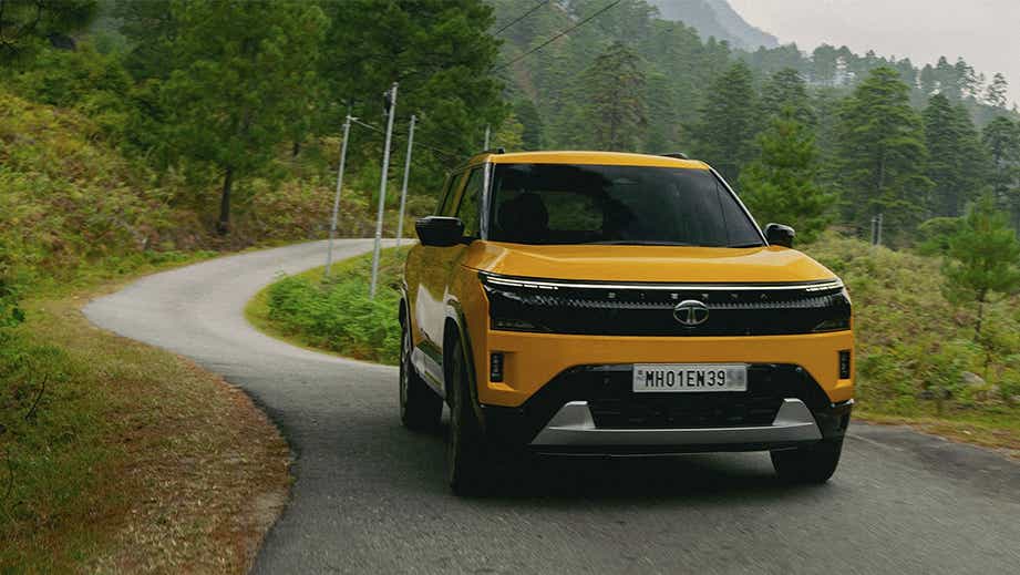 Front view of a Tata Sierra on a winding road