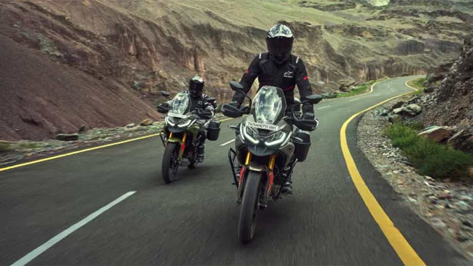 Front view of a TVS Apache RTX on a winding road