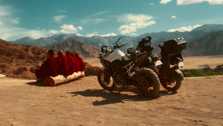 Side view of a TVS Apache RTX motorcycle in the mountains