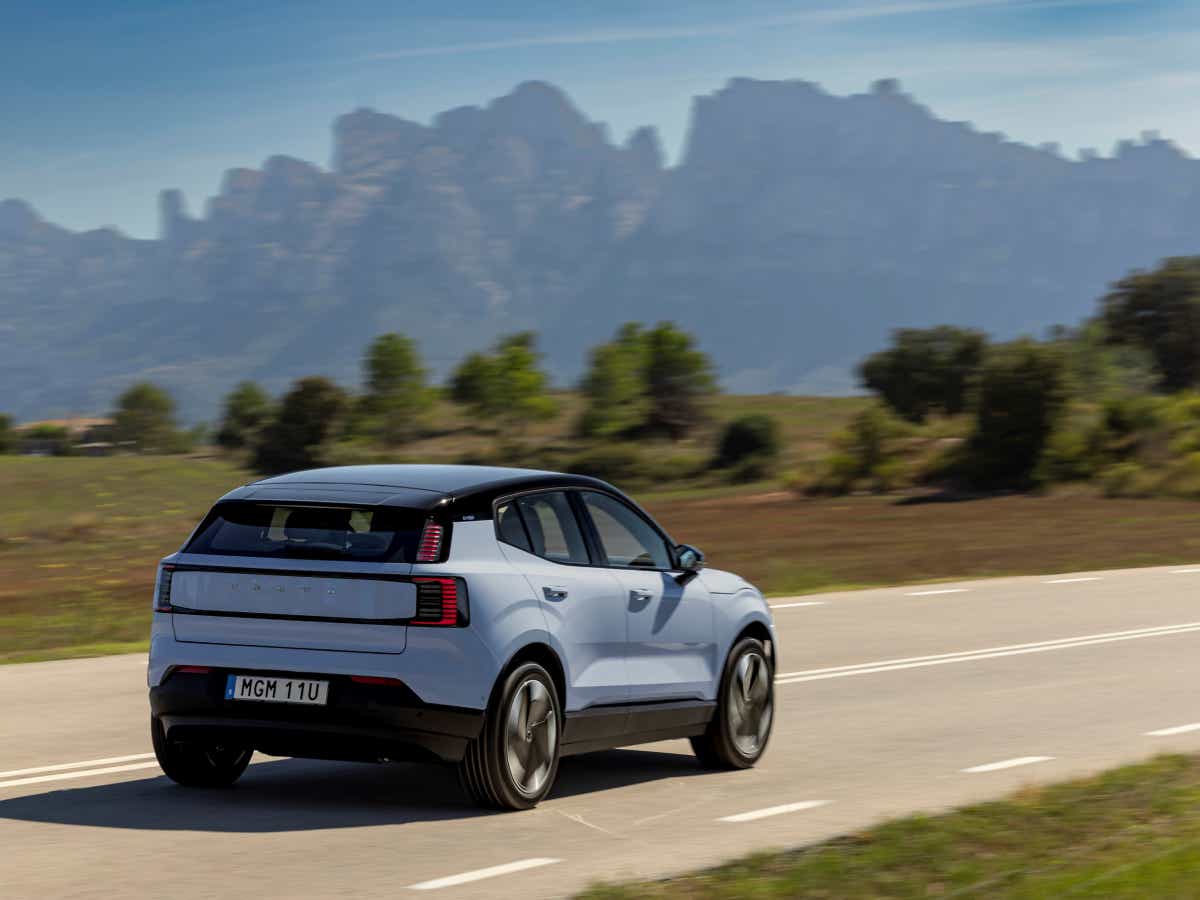 Rear three-quarter of a cold blue Volvo EX30