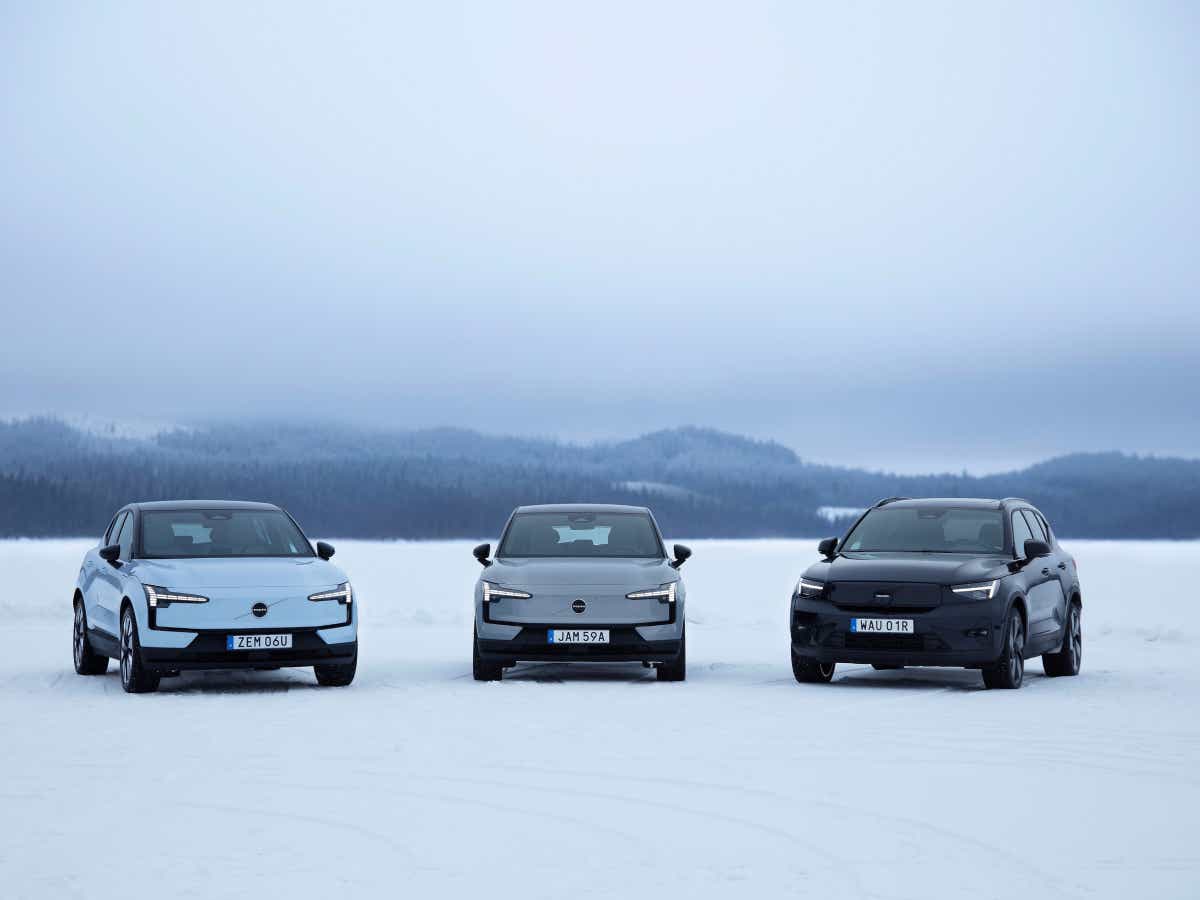 Front view of three Volvo EX30 cars on a snowy landscape