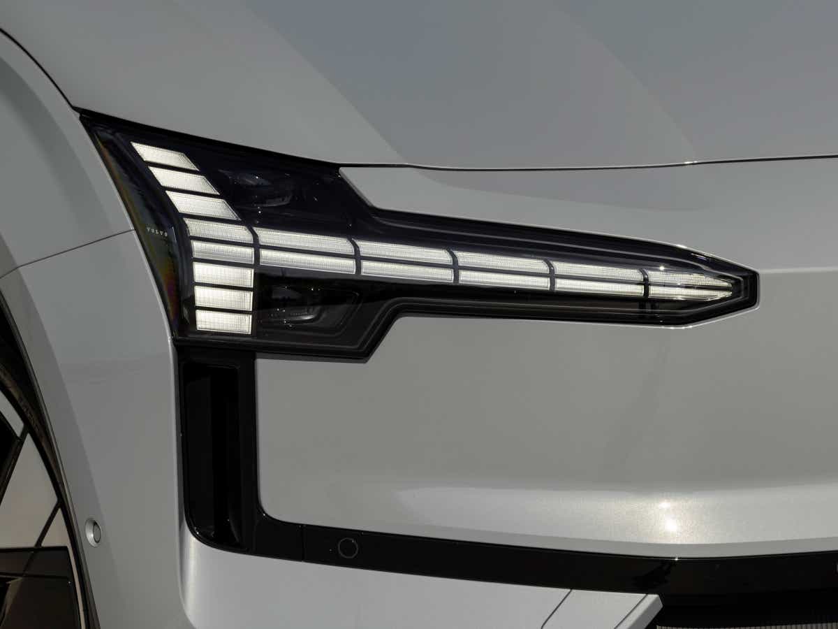 Headlight close-up of a crystal white Volvo EX30