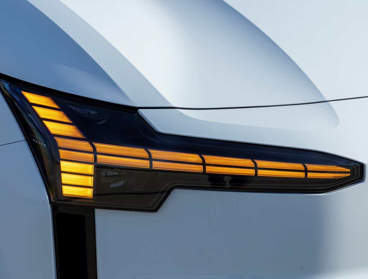 Headlight close-up of a crystal white Volvo EX30