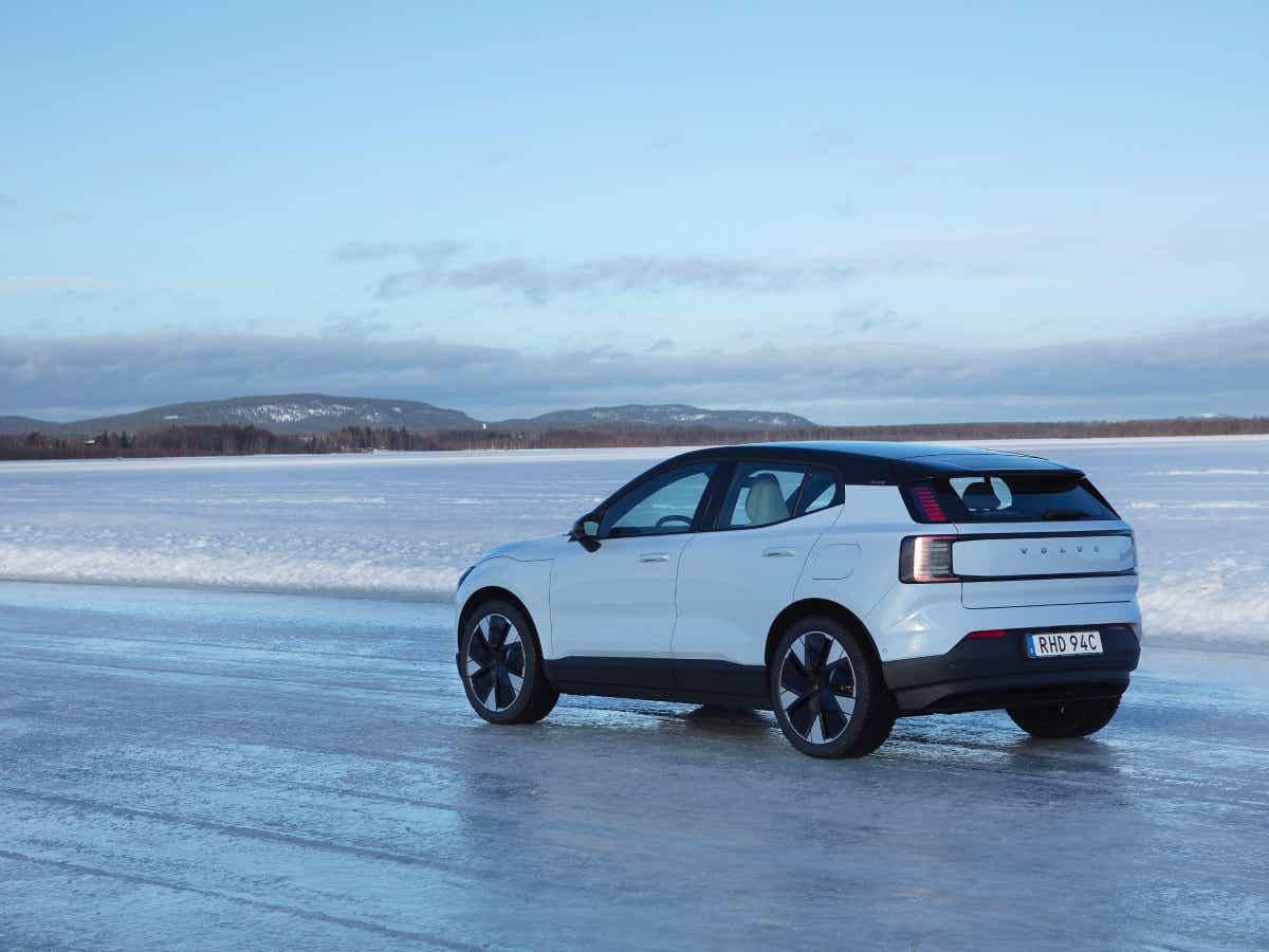 Rear three-quarter of a crystal white Volvo EX30