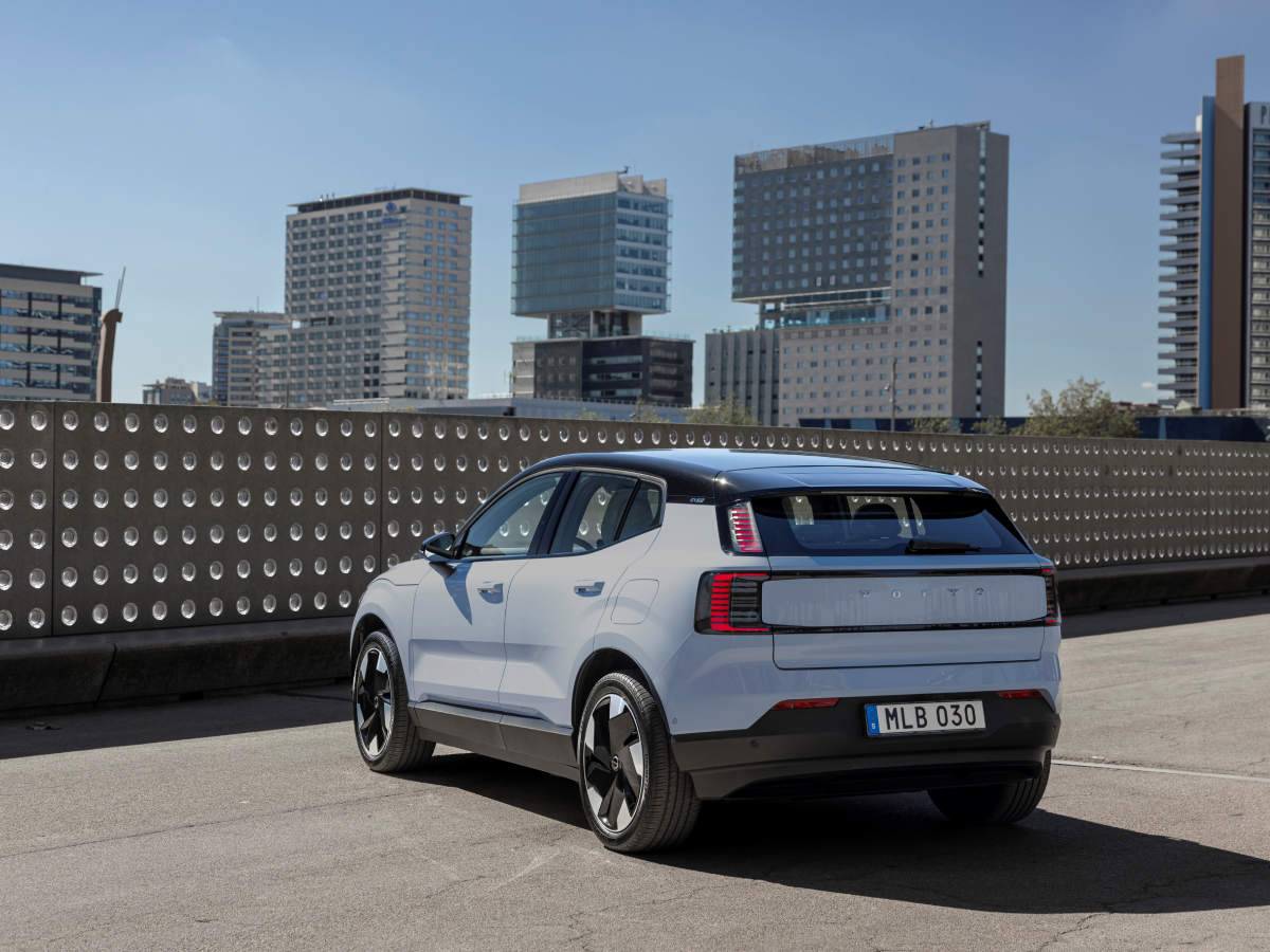 Rear three-quarter of a crystal white Volvo EX30
