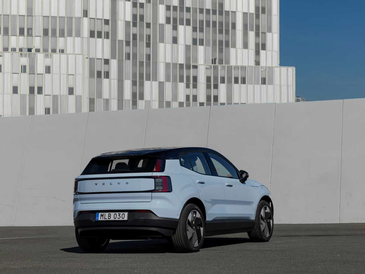 Rear three-quarter of a cold blue Volvo EX30