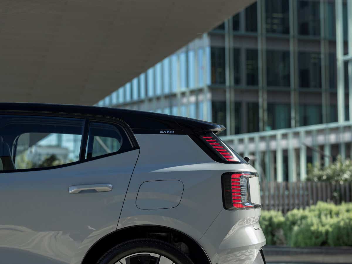 Rear three-quarter of a crystal white Volvo EX30